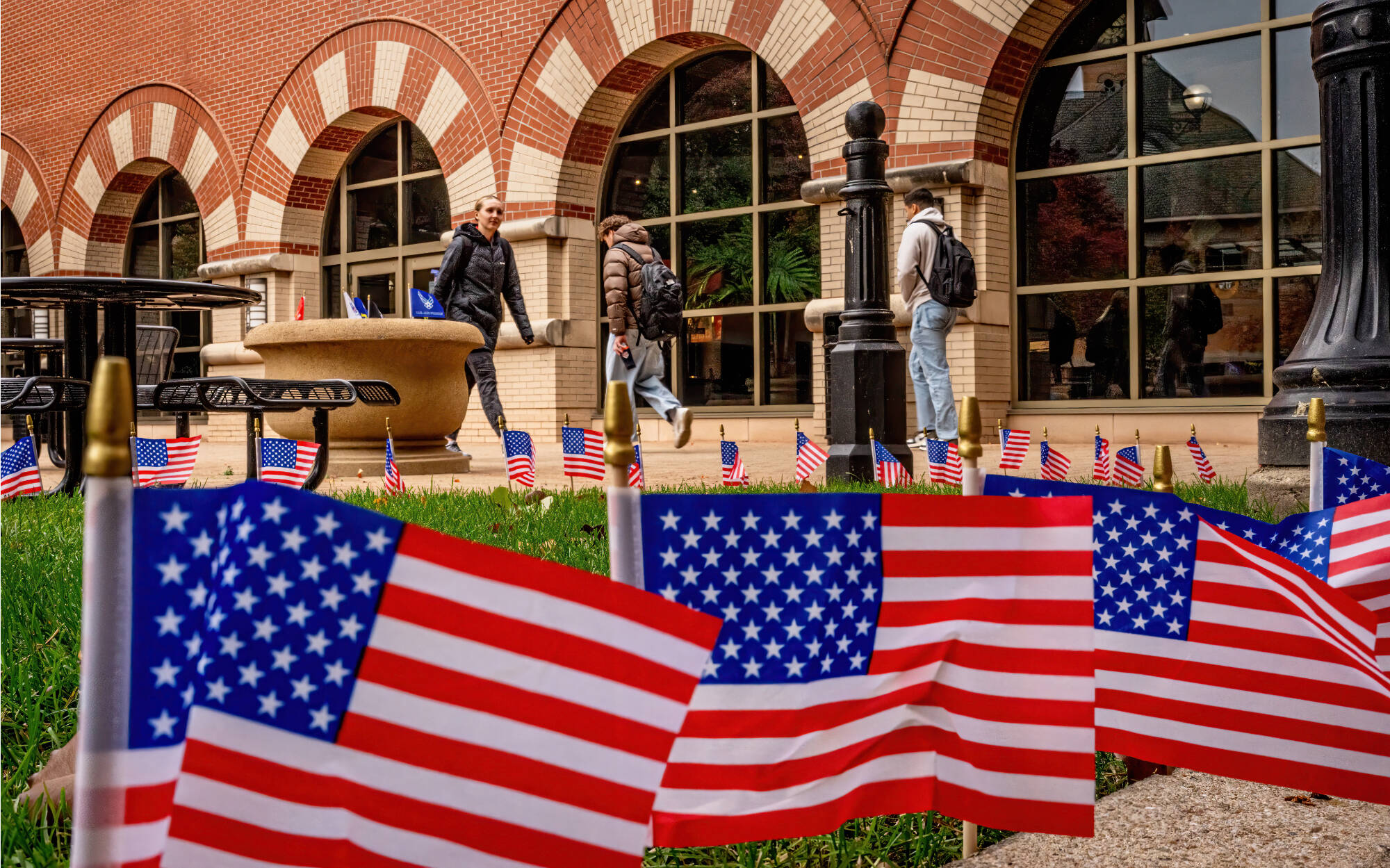 Veteran’s Day flags surround the courtyard on the Richard M. DeVos Center on the Robert C. Pew Grand Rapids Campus. 2025-11-11. Photography by Steve Jessmore